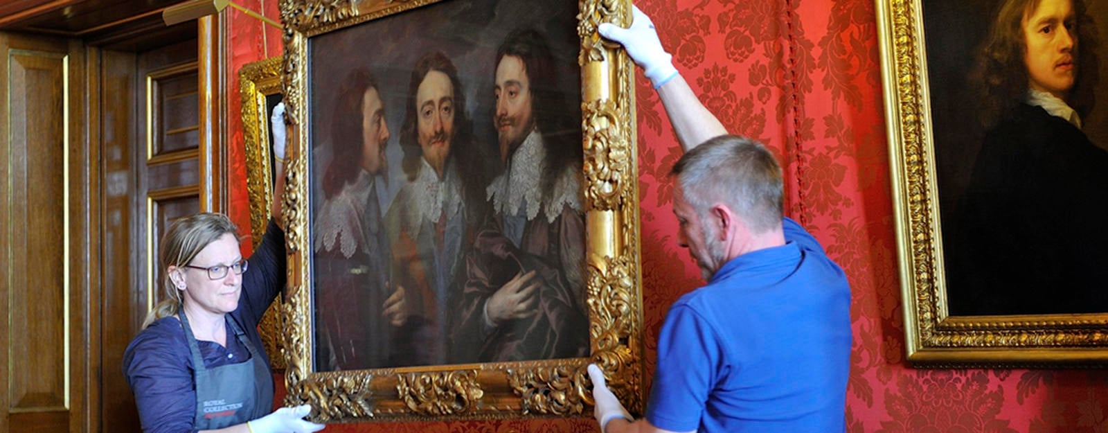 Painting being moved by art handlers