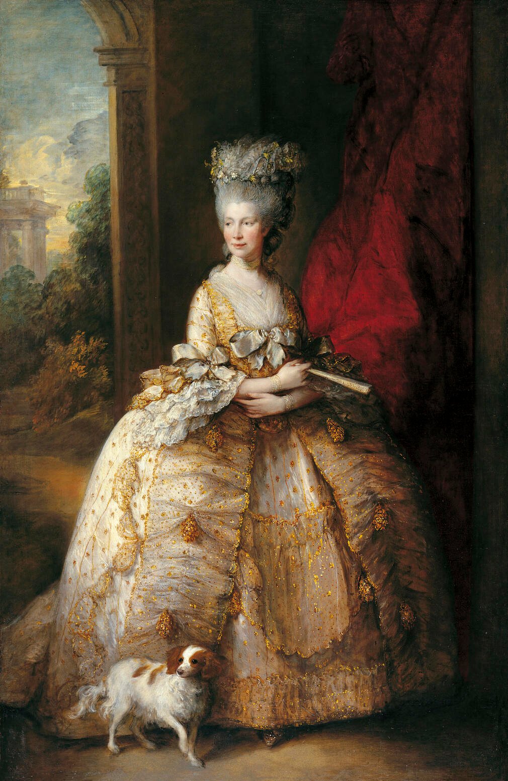 Queen Charlotte in a magnificent gown, worn over a wide hoop and covered with gold spangles and tassels. Queen Charlotte in a magnificent gown, worn over a wide hoop and covered with gold spangles and tassels.