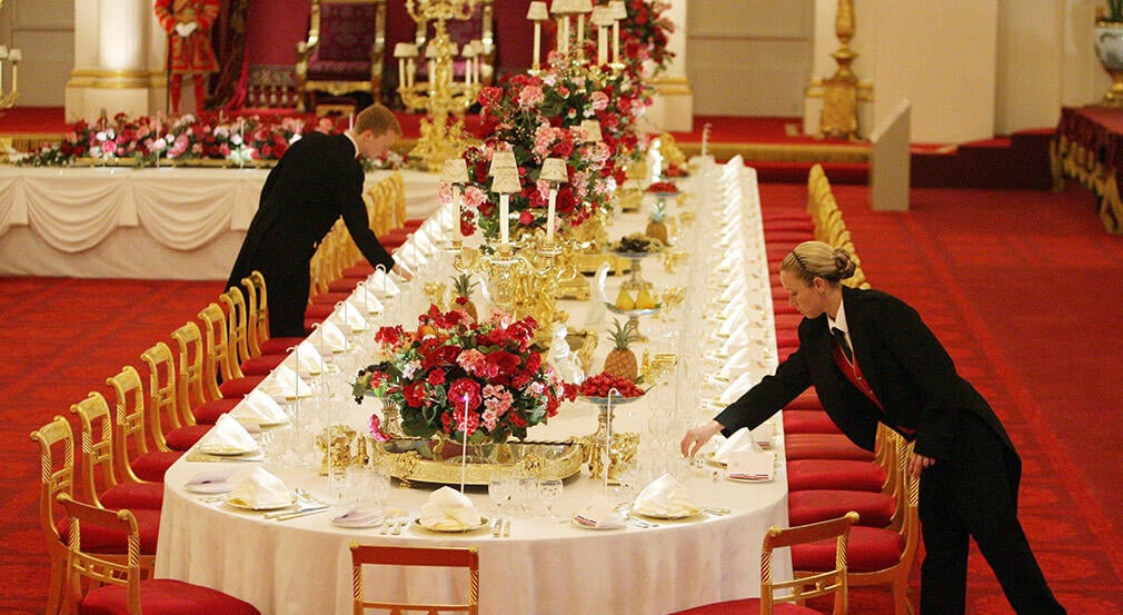 Staff members lay the State Banquet table, in the ballroom at Buckingham Palace. Staff members lay the State Banquet table, in the ballroom at Buckingham Palace.
