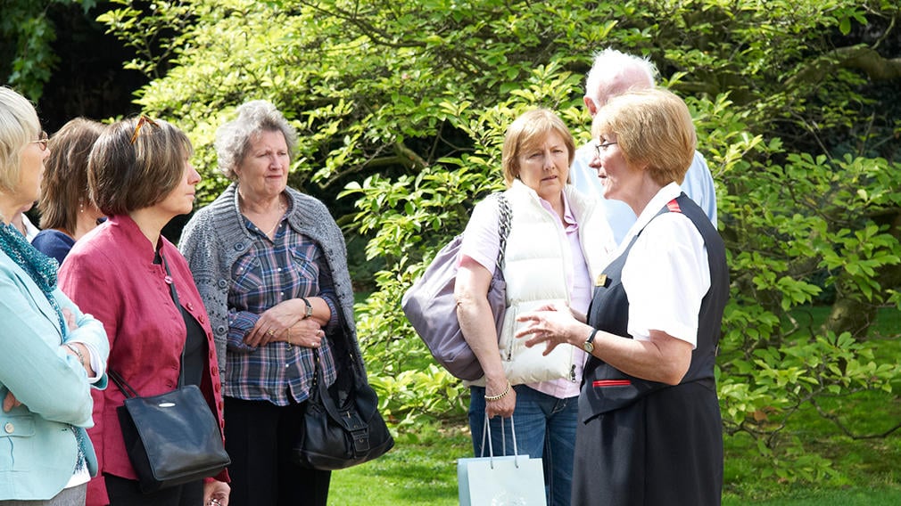A warden with a group in the garden at Clarence House A warden with a group in the garden at Clarence House