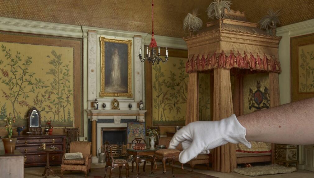 The King's Bedroom in Queen Mary's Dolls' House The King's Bedroom in Queen Mary's Dolls' House with a hand reaching in to pick up furniture