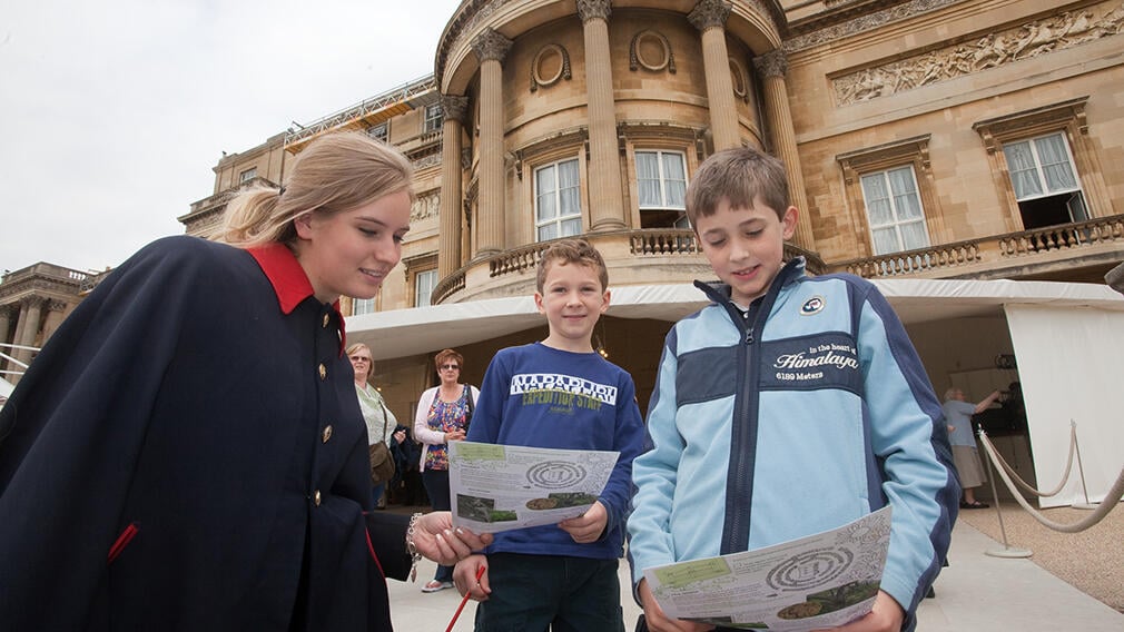 Children with a warden at Buckingham Palace Children with a warden at Buckingham Palace