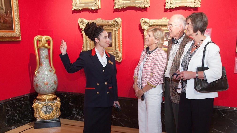 Warden with visitors to The King's Gallery, Buckingham Palace Warden with visitors to The King's Gallery, Buckingham Palace