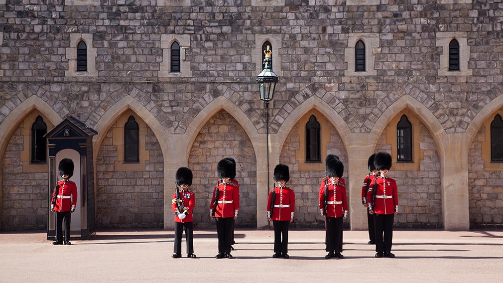The guards at Windsor Castle Guards stand in front of castle wall in Windsor Castle