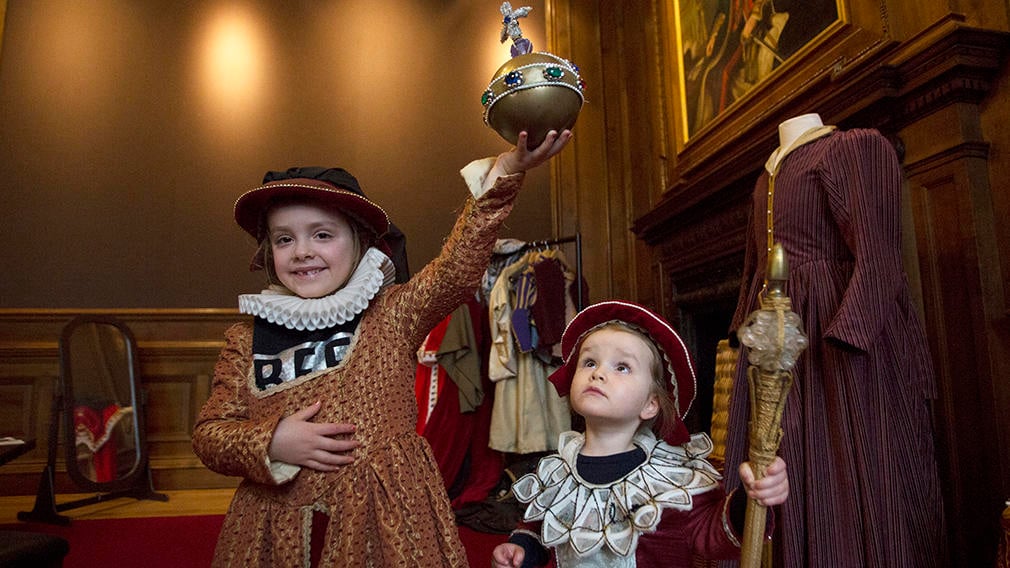 Children enjoying dressing up in the Palace Two children dressed up in historical costumes in the Palace
