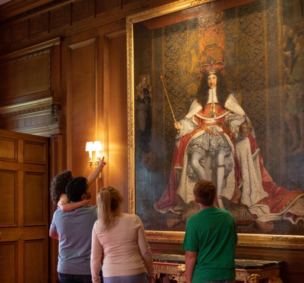 Portrait of Charles II by John Michael Wright (RCIN 404951) A family looking at the portrait of Charles II by John Michael Wright (RCIN 404951)
