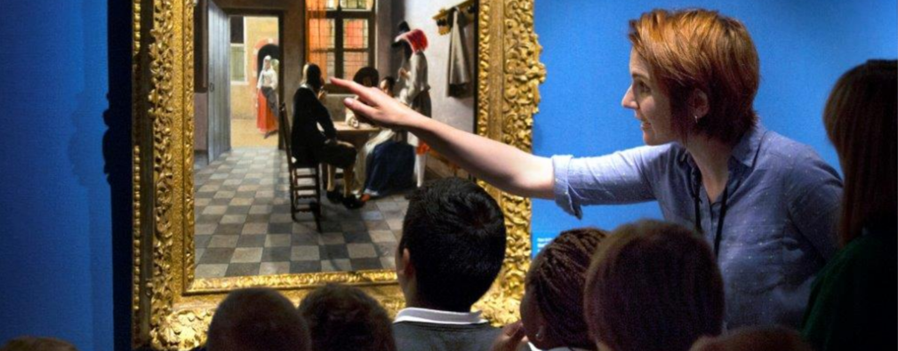 Pupils studying a painting in The Queen's Gallery, Buckingham Palace Group of school pupils and teacher looking closely at a painting on a gallery wall